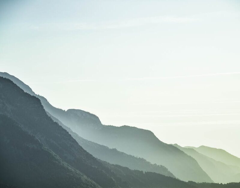 Mountain Landscapes - A serene view of misty mountain layers in Schwaz #1054222