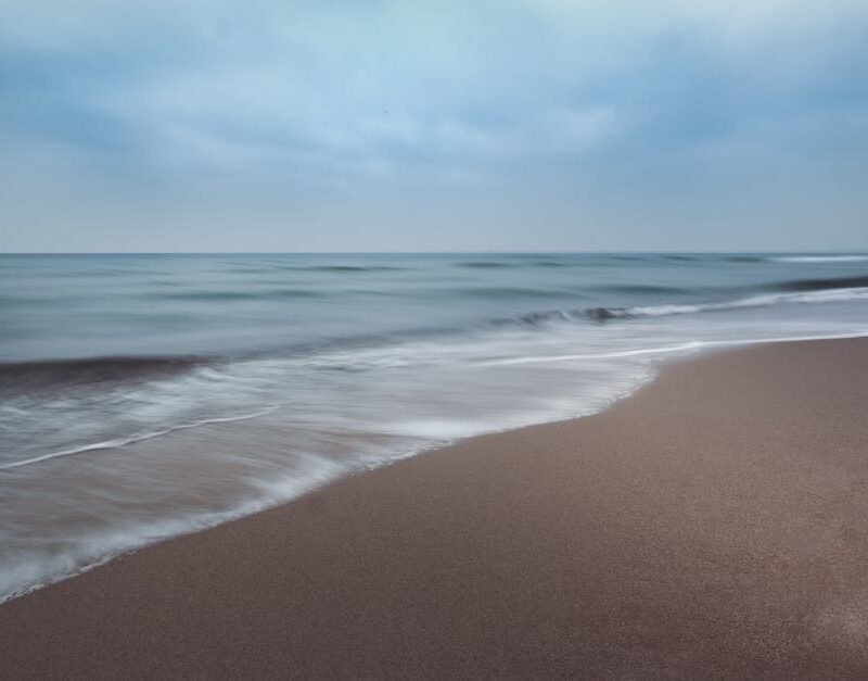 Beach Scenery - Tranquil ocean waves softly crashing on a sandy #12399620