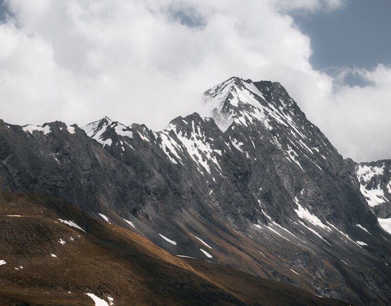 Snow Mountains - Soaring snow-capped peaks against cloudy skies i #12940688