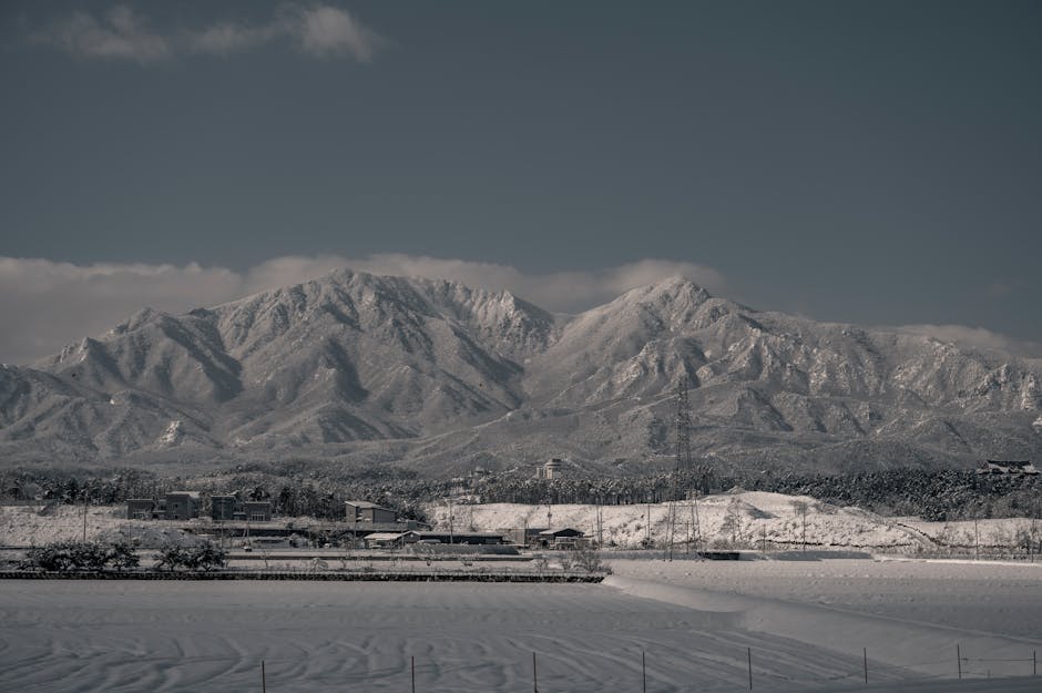 Snow Mountains - Snow-capped mountains rise above a serene town, #15201467