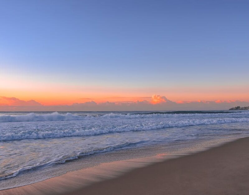 Beach Scenery - Peaceful beach scene at sunrise with gentle wave #16354140