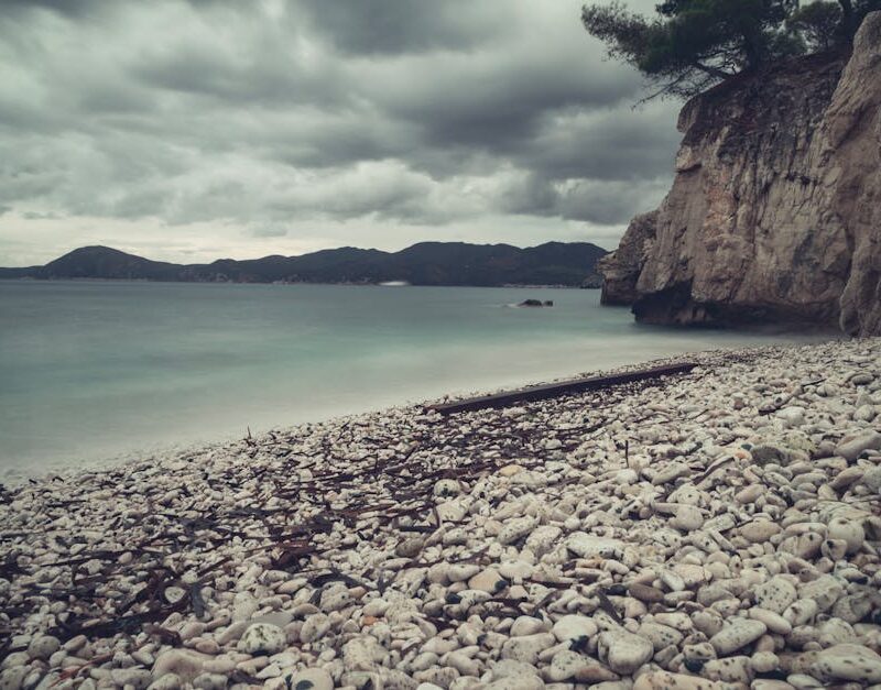 Beach Scenery - Stormy skies over a pebbled beach in Portoferrai #18582298