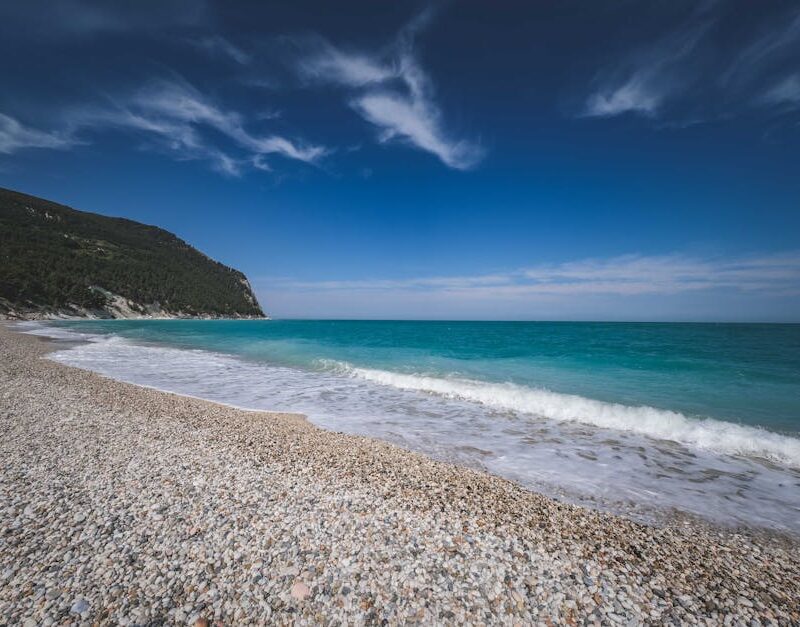 Beach Scenery - Peaceful pebble beach and turquoise ocean agains #19498660