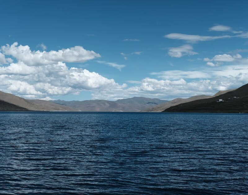 Lake Reflections - Tranquil mountain lake under a bright blue sky, #20499743