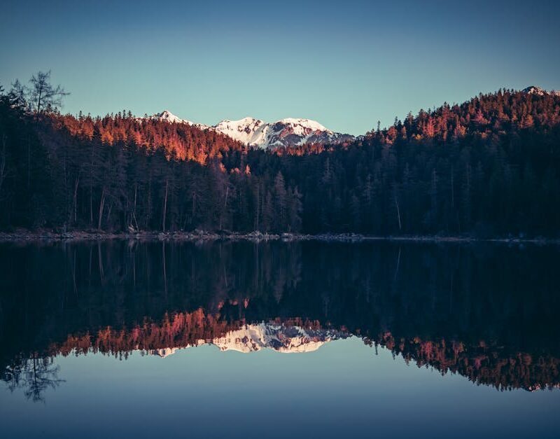 Lake Reflections - A tranquil lake reflects snowcapped mountains an #20755869