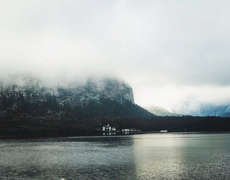 Lake Reflections - Serene lake with misty mountain backdrop and clo #28593673