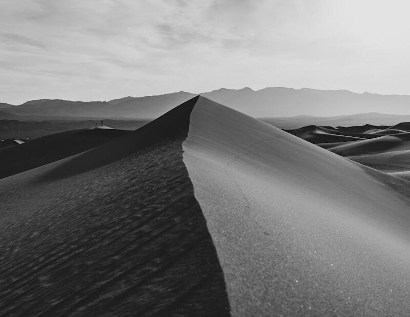 Desert Wilderness - Monochrome image of sand dunes with mountains in #28639219