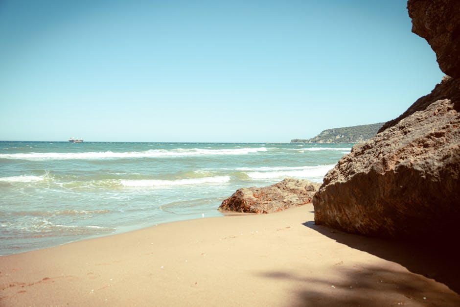 Beach Scenery - A tranquil beach scene featuring a rocky outcrop #33596222