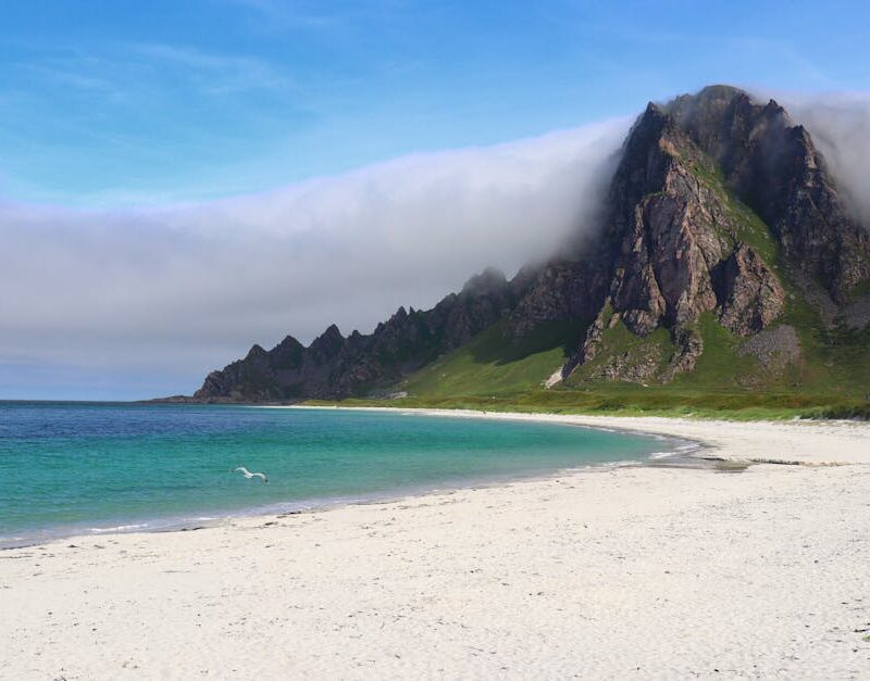 Beach Scenery - Explore the tranquil beach with towering mountai #34146948