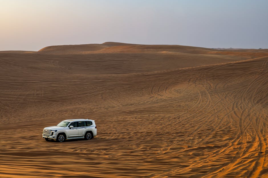 Desert Wilderness - White SUV traversing expansive desert dunes at s #35110924