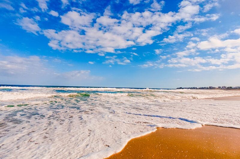Beach Scenery - Vibrant beach scene with waves crashing on shore #35853044