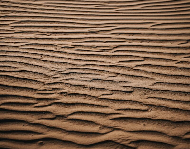Desert Wilderness - A detailed view of rippling sand patterns in a d #36246171
