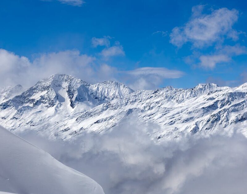 Snow Mountains - Snow-covered mountains with blue sky and clouds #36524855