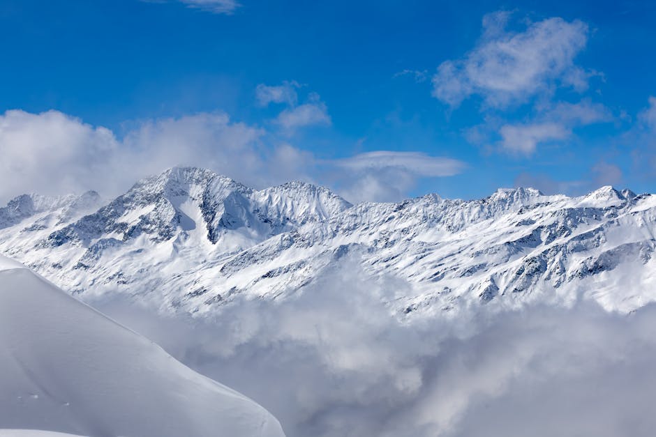 Snow Mountains - Snow-covered mountains with blue sky and clouds #36524855