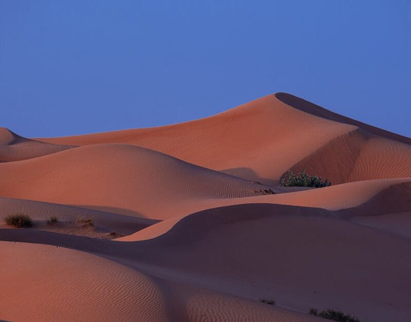 Desert Wilderness - A tranquil view of desert sand dunes under a twi #7271881