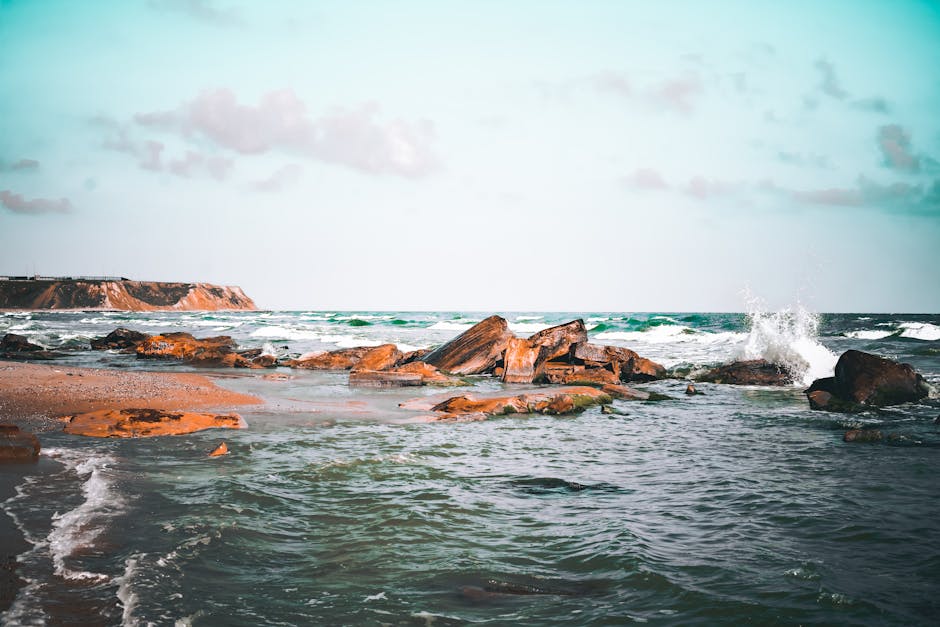 Beach Scenery - A tranquil beach scene featuring a rocky shoreli #7469959